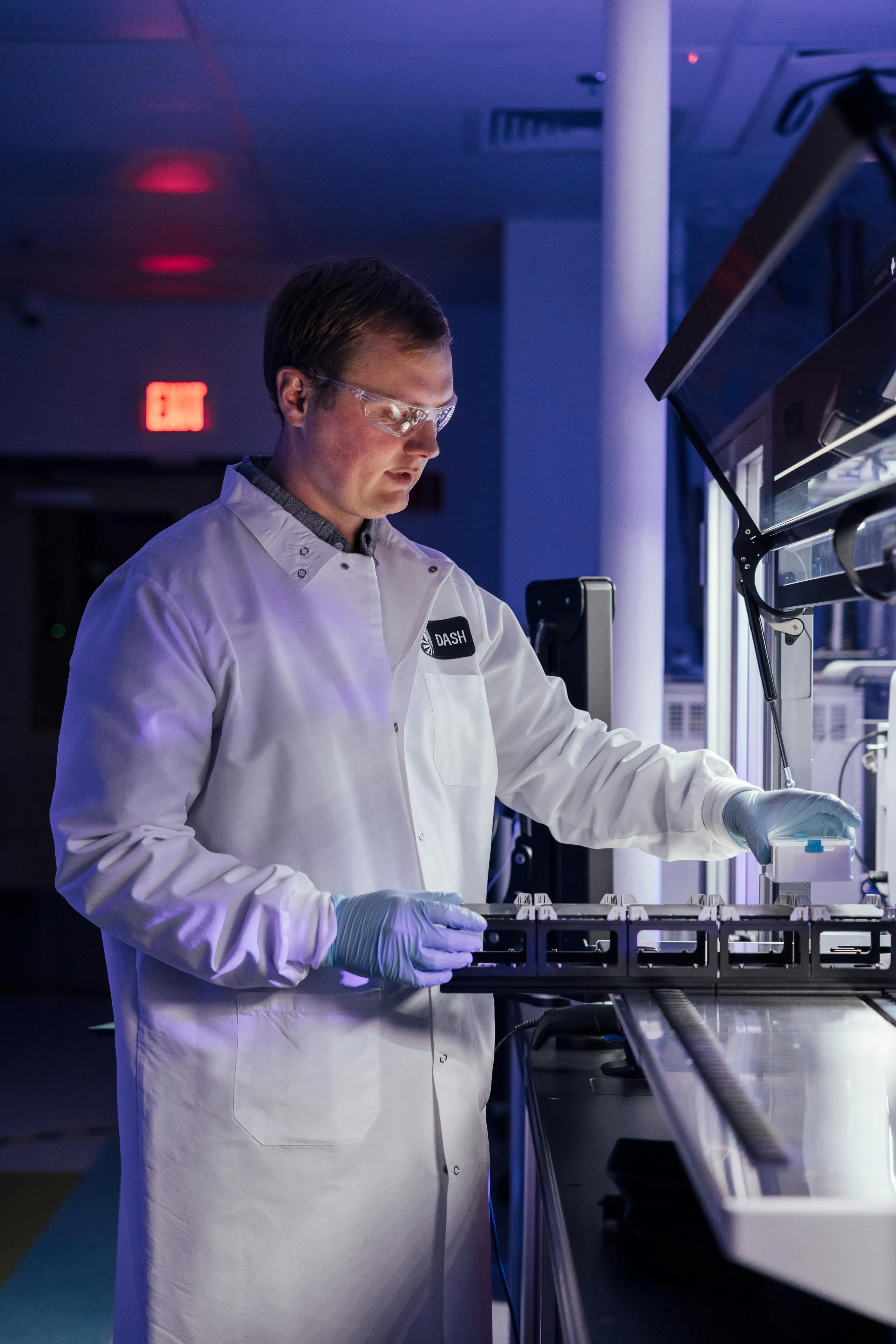 A scientist loading Dash Bio's automated platform to run an assay